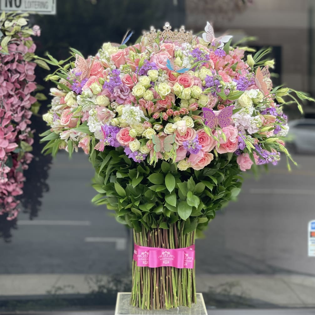 Large bouquet of pink and purple flowers with butterflies