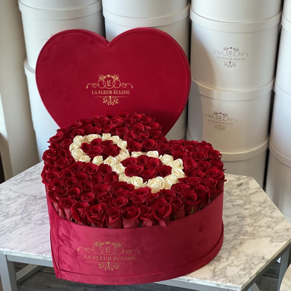 Heart-shaped box filled with red and white roses