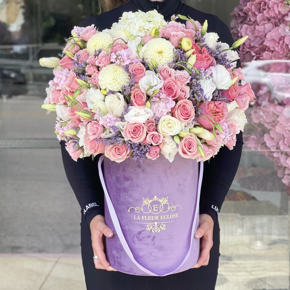 Large pink and white rose bouquet in a purple hatbox