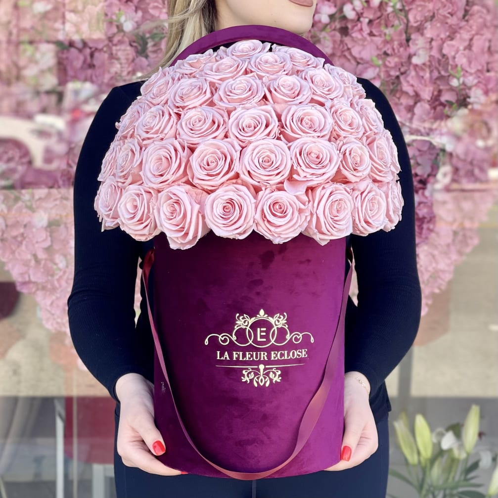 Large pink rose bouquet in a purple hatbox