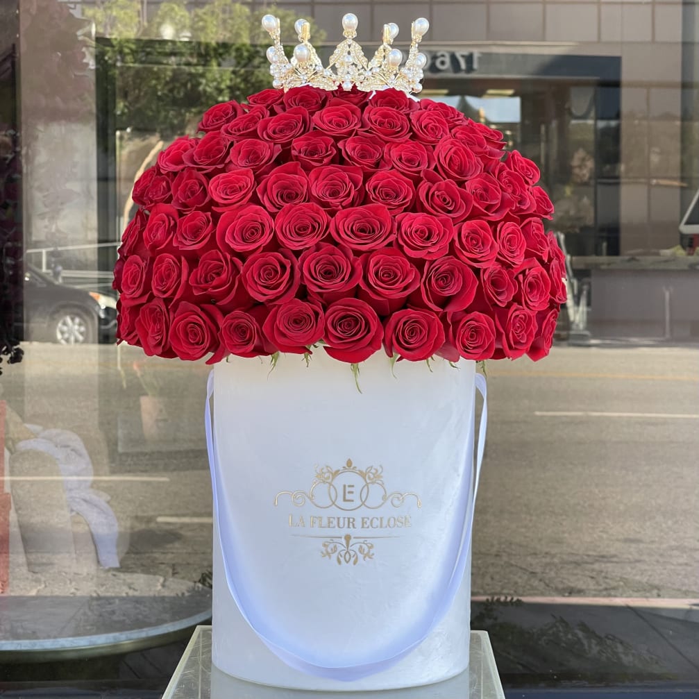 Large dome of red roses topped with a jeweled crown in a white hatbox