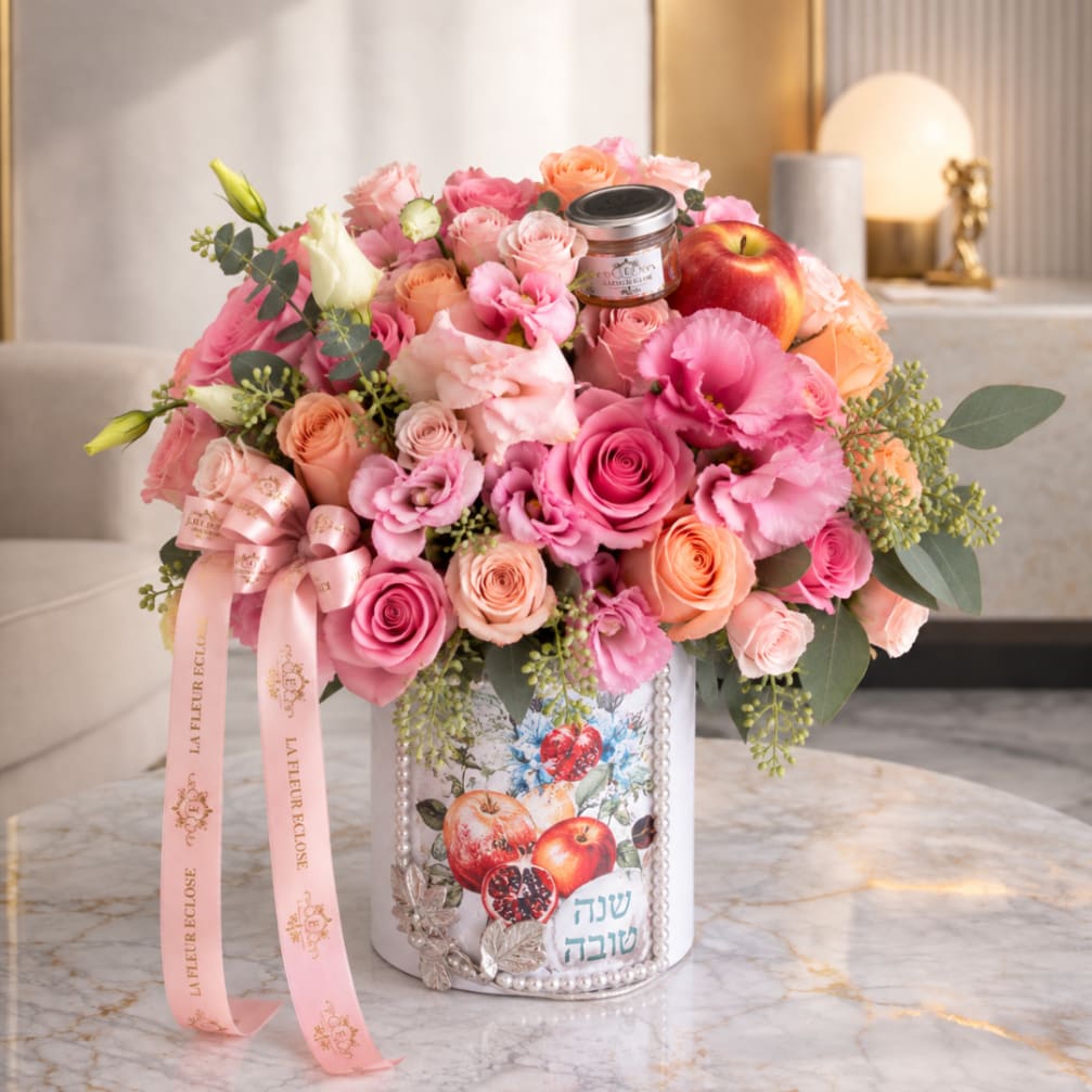 Pink and peach rose bouquet in a decorated tin with an apple and ribbon
