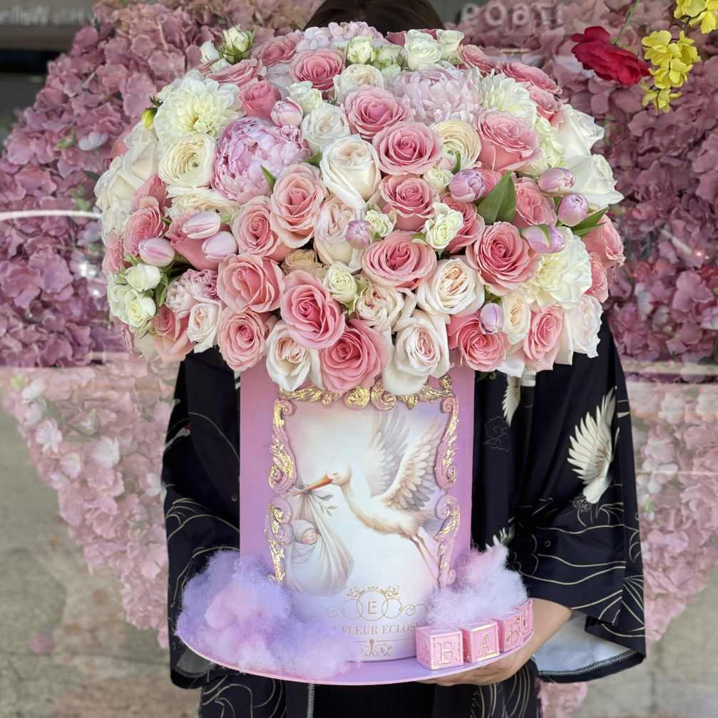 Pink and white rose arrangement in a decorative box with a bird illustration