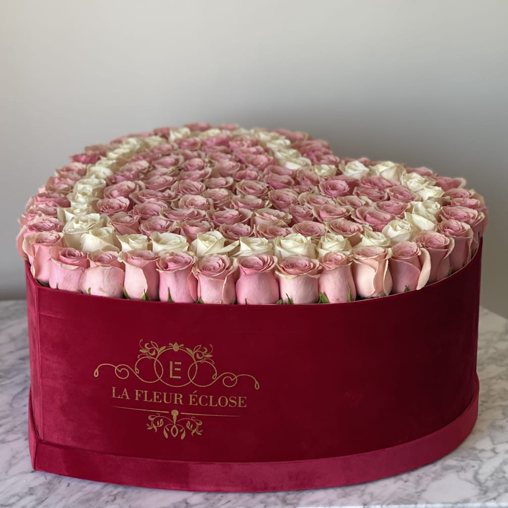 Heart-shaped box filled with pink and white roses