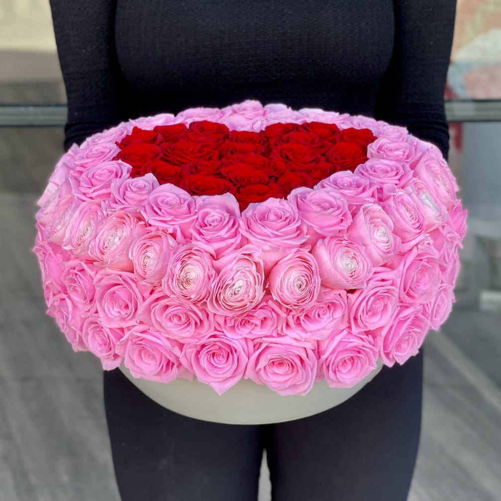 Heart-shaped box filled with pink and red roses