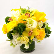 Yellow and white floral arrangement in a glass vase