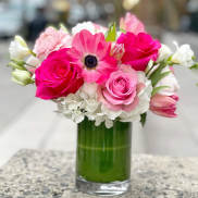 Pink and white bouquet in a clear glass vase