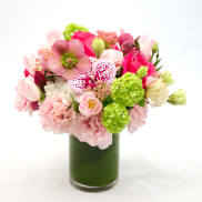 Pink and white mixed bouquet in a tall glass vase
