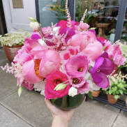 Pink bouquet with calla lilies, roses, and peonies in a glass vase