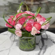 Pink ranunculus bouquet in a clear glass vase