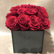 Box of red roses in a black square container