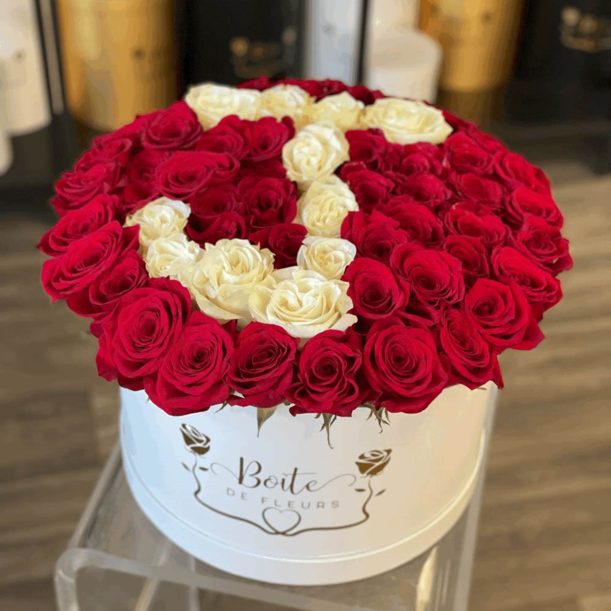Round box of red and white roses arranged in a heart pattern