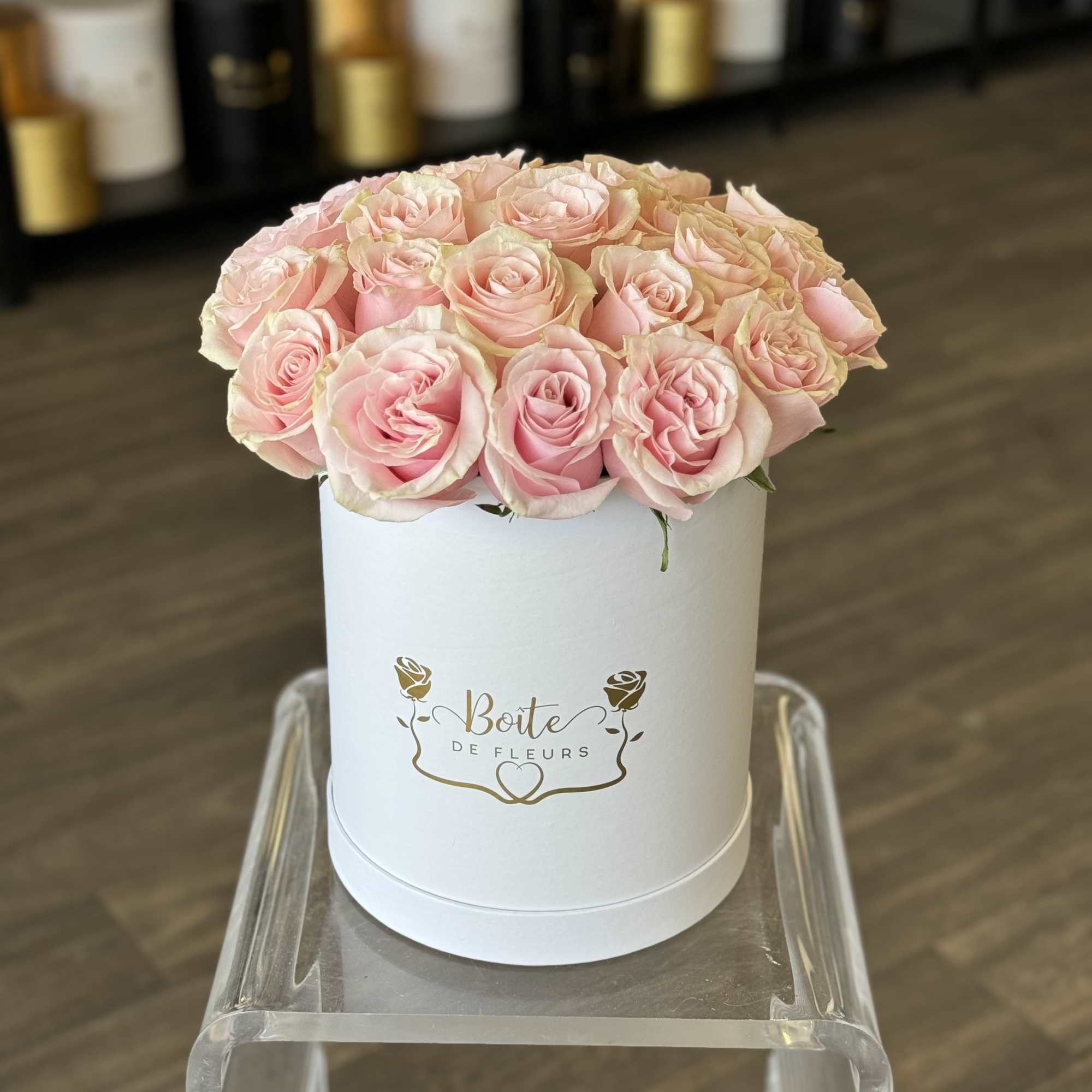 Pink roses arranged in a white round box