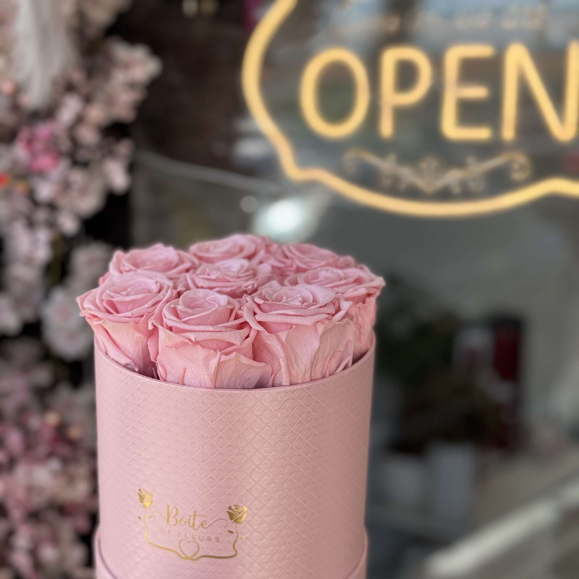 Pink roses arranged in a round pink box