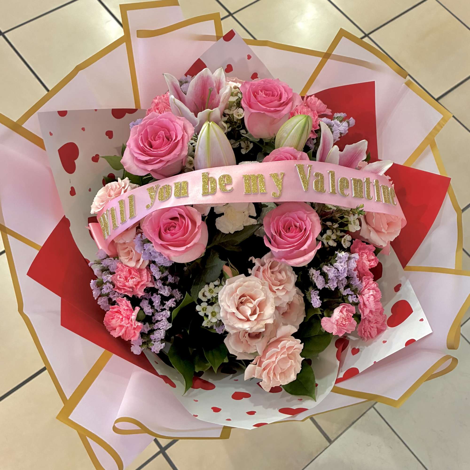 Pink rose and lily bouquet with a Valentine ribbon
