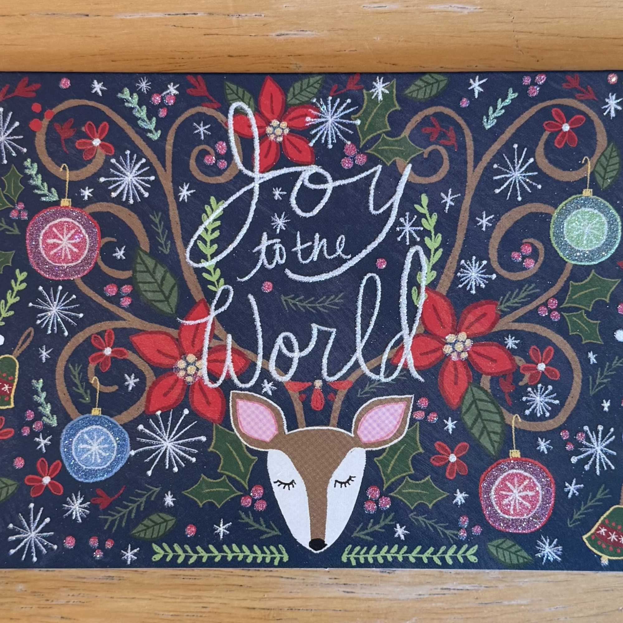 Holiday sign with a deer and the words Joy to the World