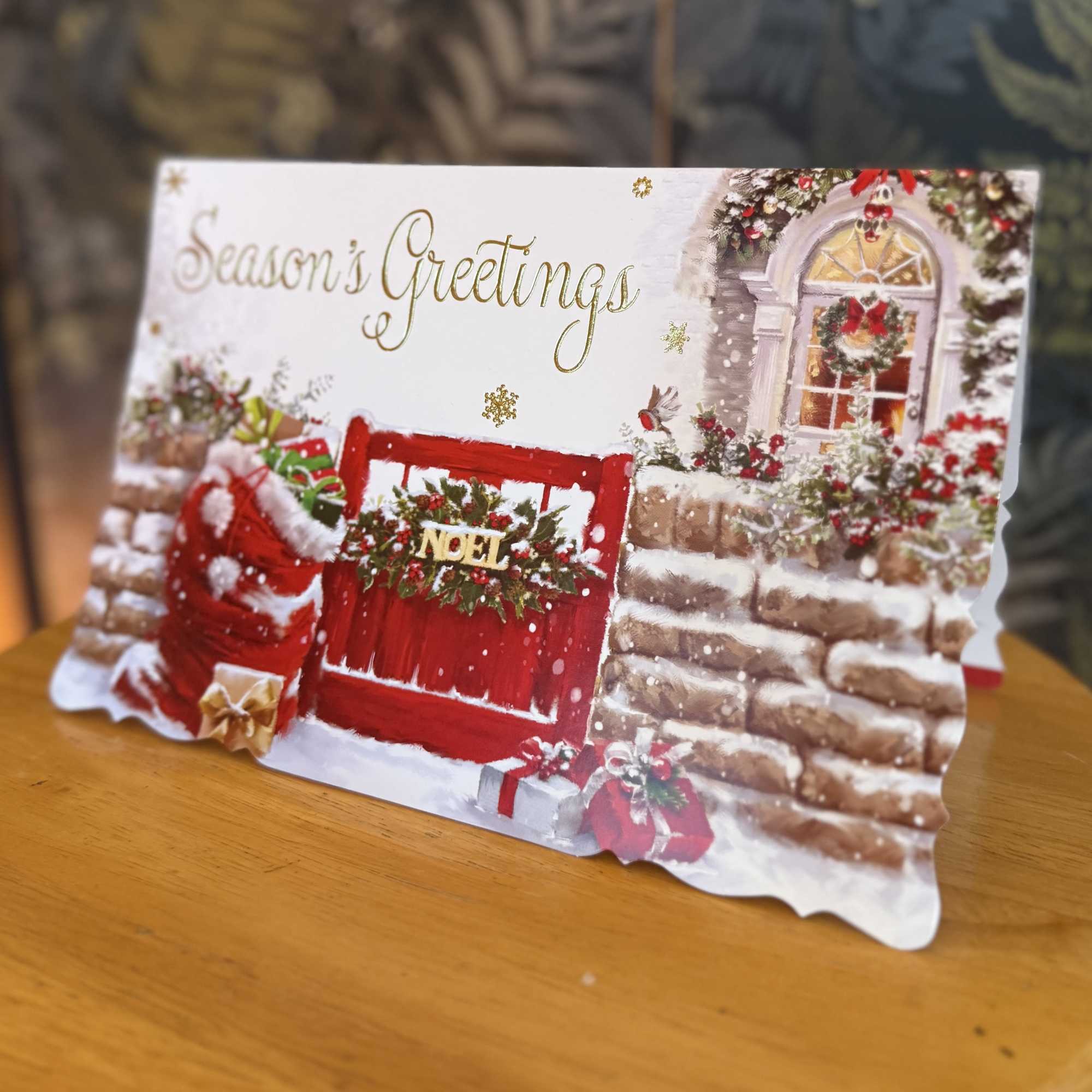 A Christmas greeting card with a red door and holiday decorations