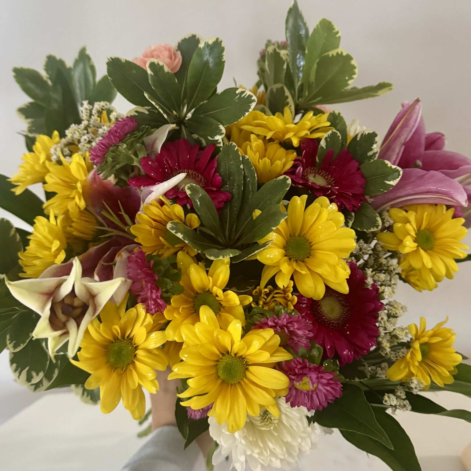 Mixed bouquet of yellow and magenta flowers with pink lilies