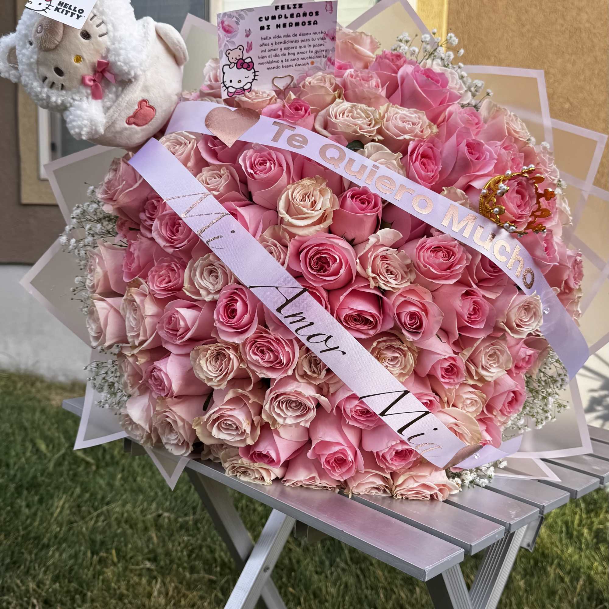 Large pink rose bouquet with a Hello Kitty plush and ribbons