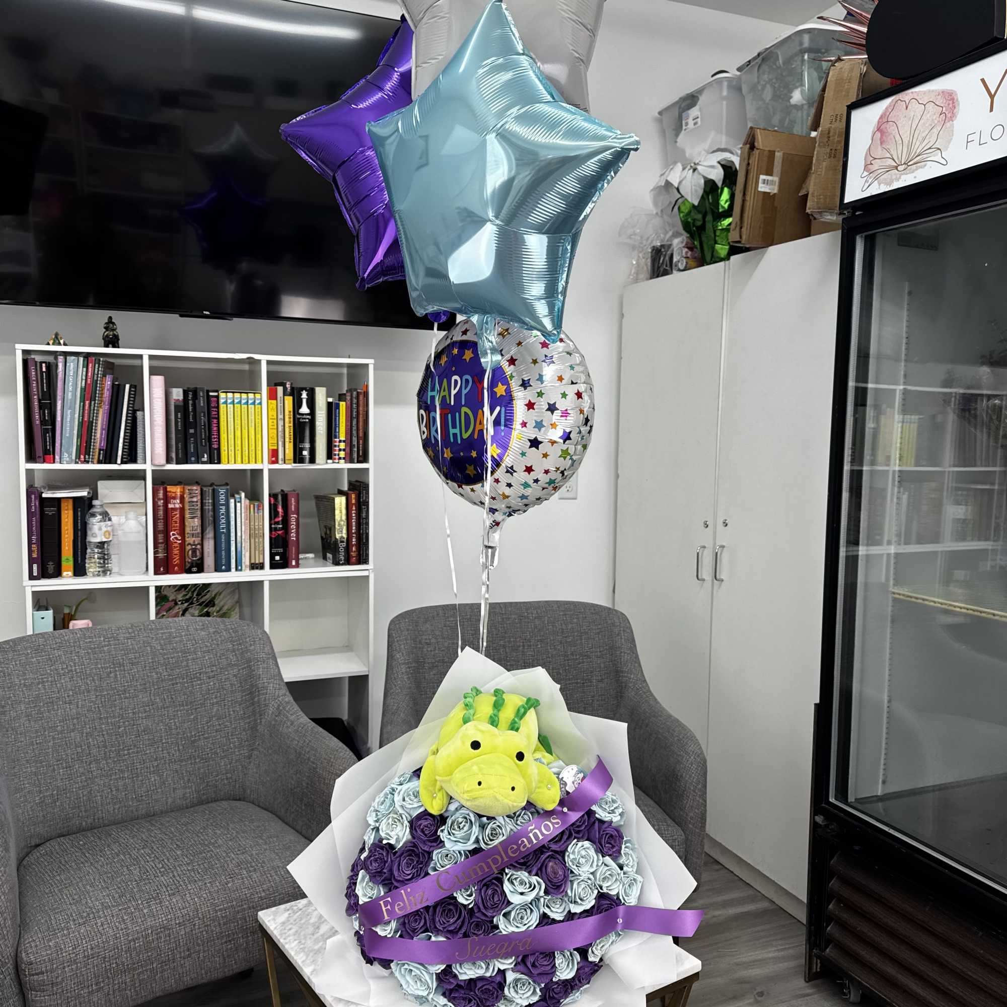 Birthday gift arrangement with rose bouquet, plush toy, and star balloons