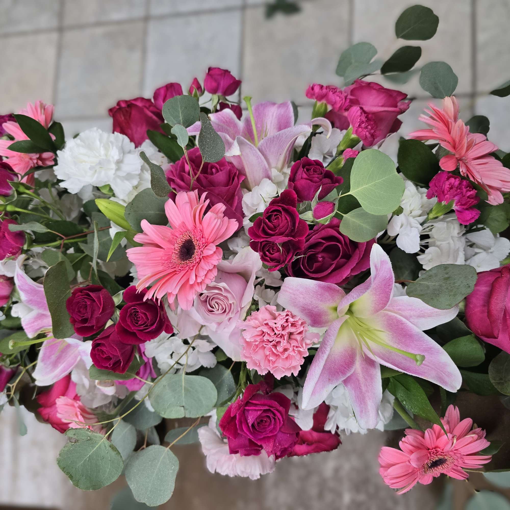 Pink and white mixed bouquet with roses, lilies, and gerbera daisies