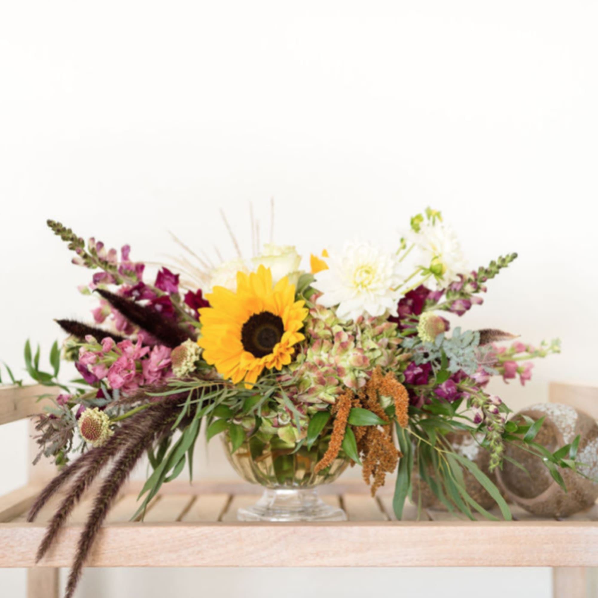 A fresh floral arrangement with season tones and blooms. The perfect centerpiece