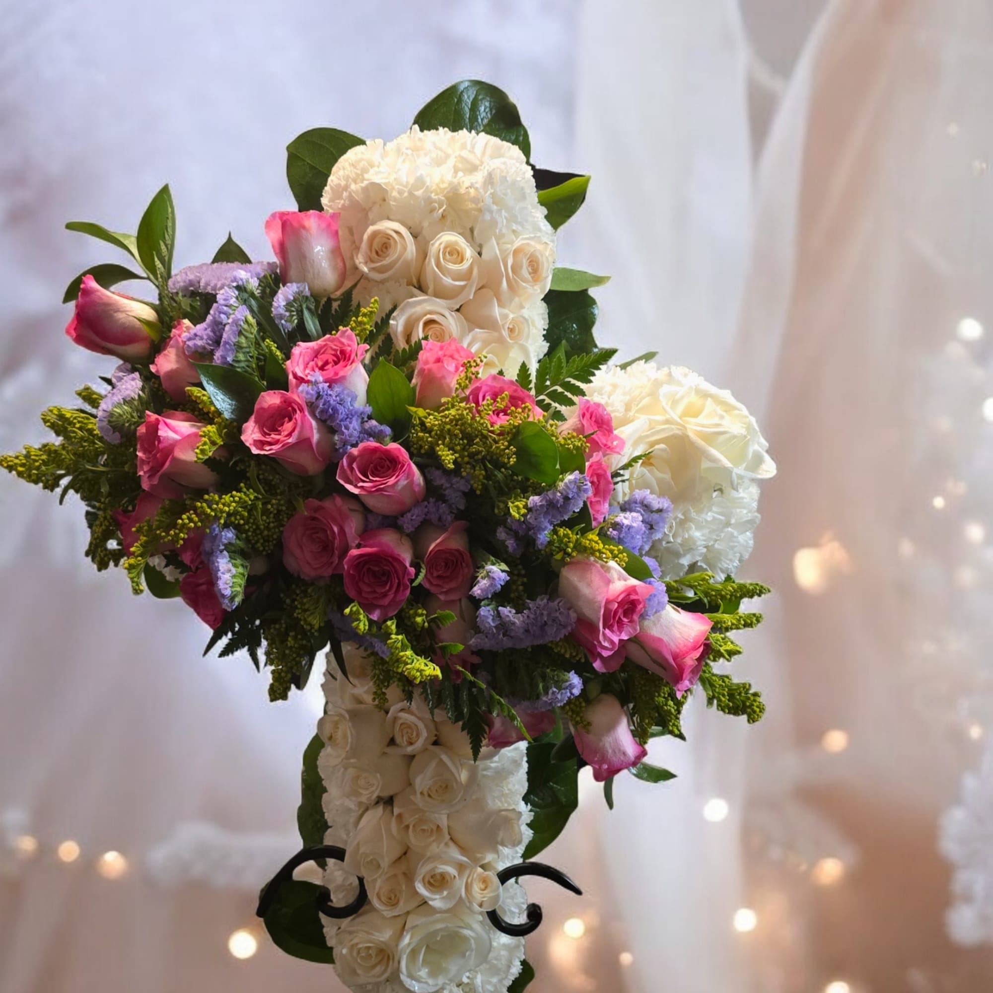 Cross-shaped floral arrangement with pink and white roses