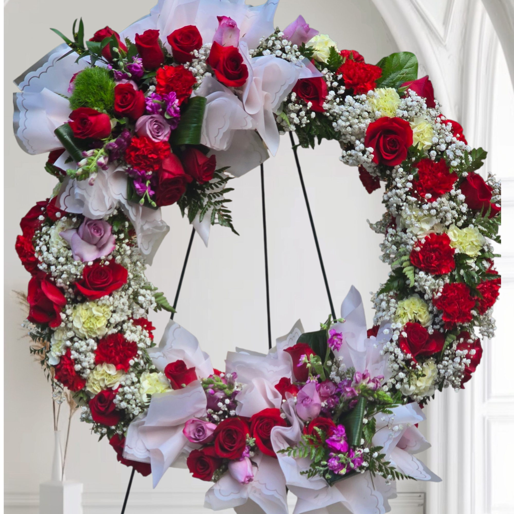 Beating Memorial wreath adorned with baby's breath Red and pink roses, red