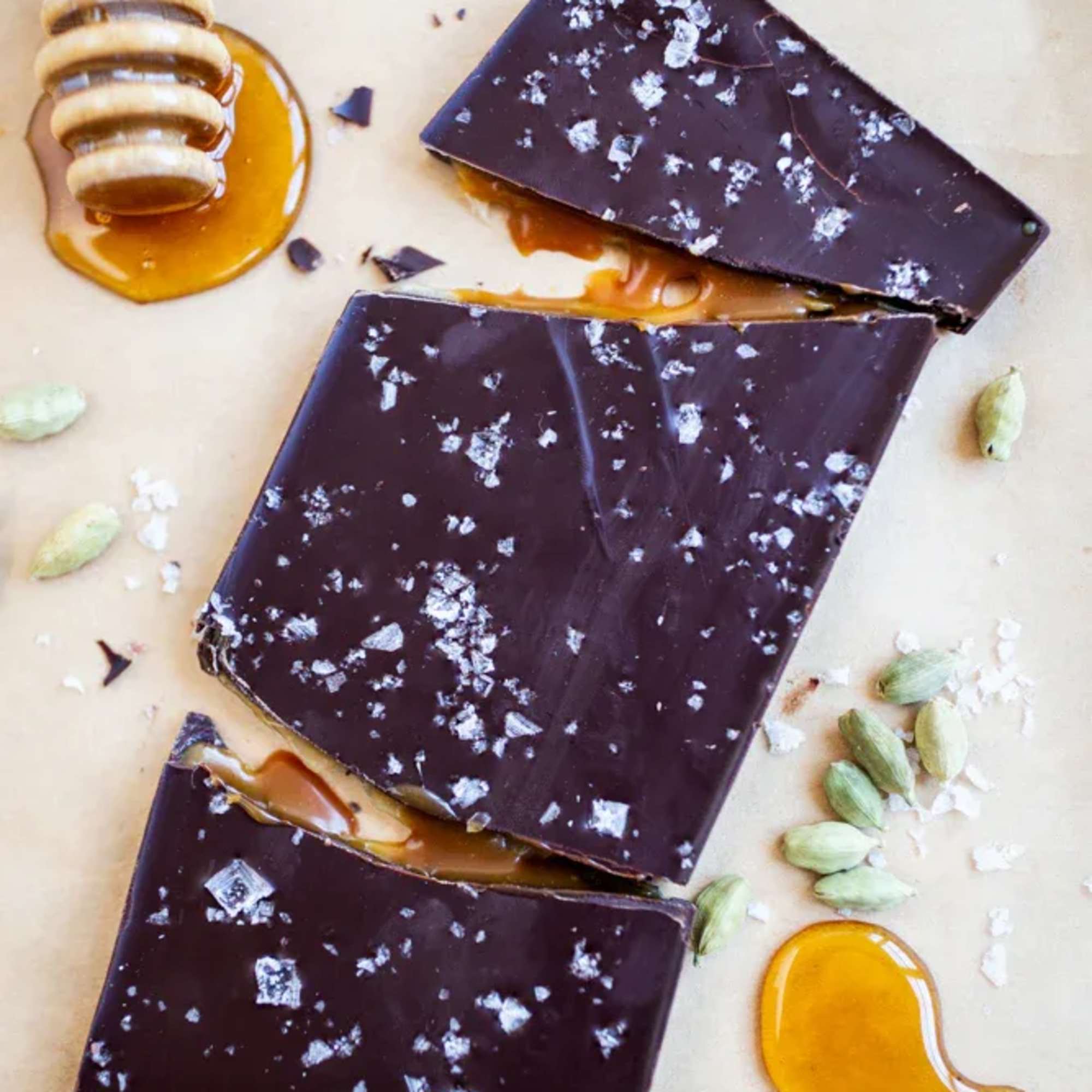 Chocolate bark pieces with honey, salt, and cardamom pods