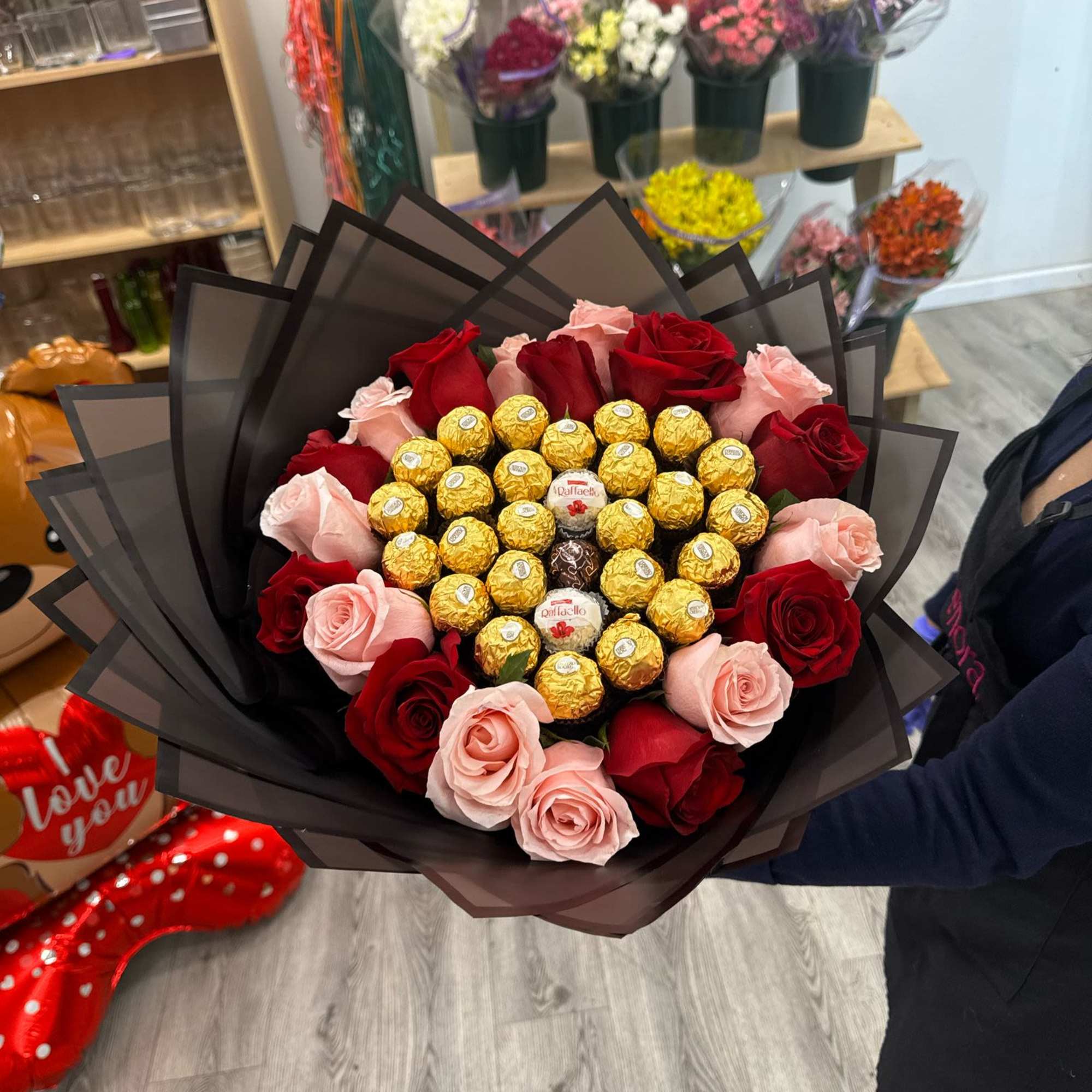 Bouquet with Ferreros chocolates and mix roses , wrapped in floral paper