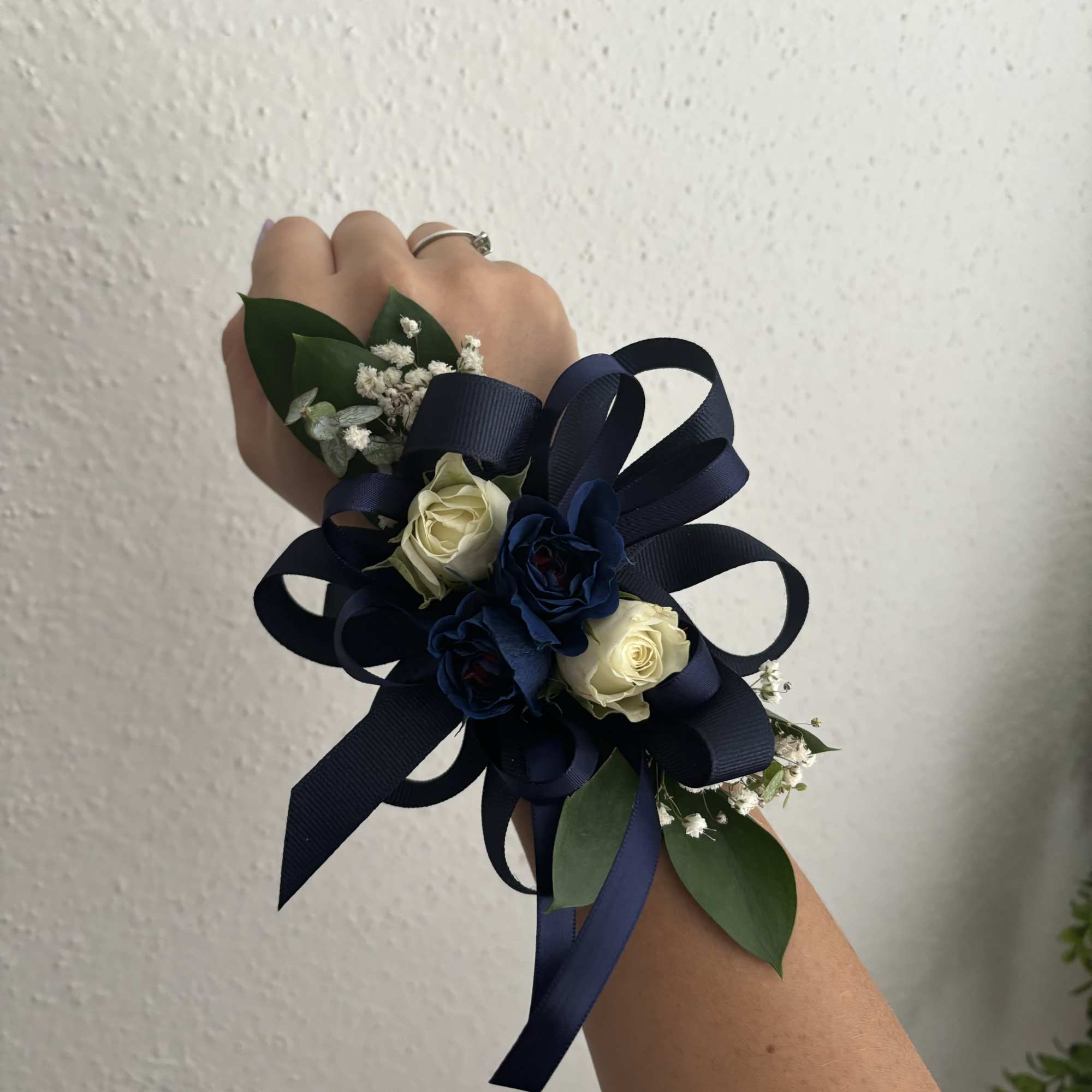 Navy ribbon wrist corsage with white and blue roses