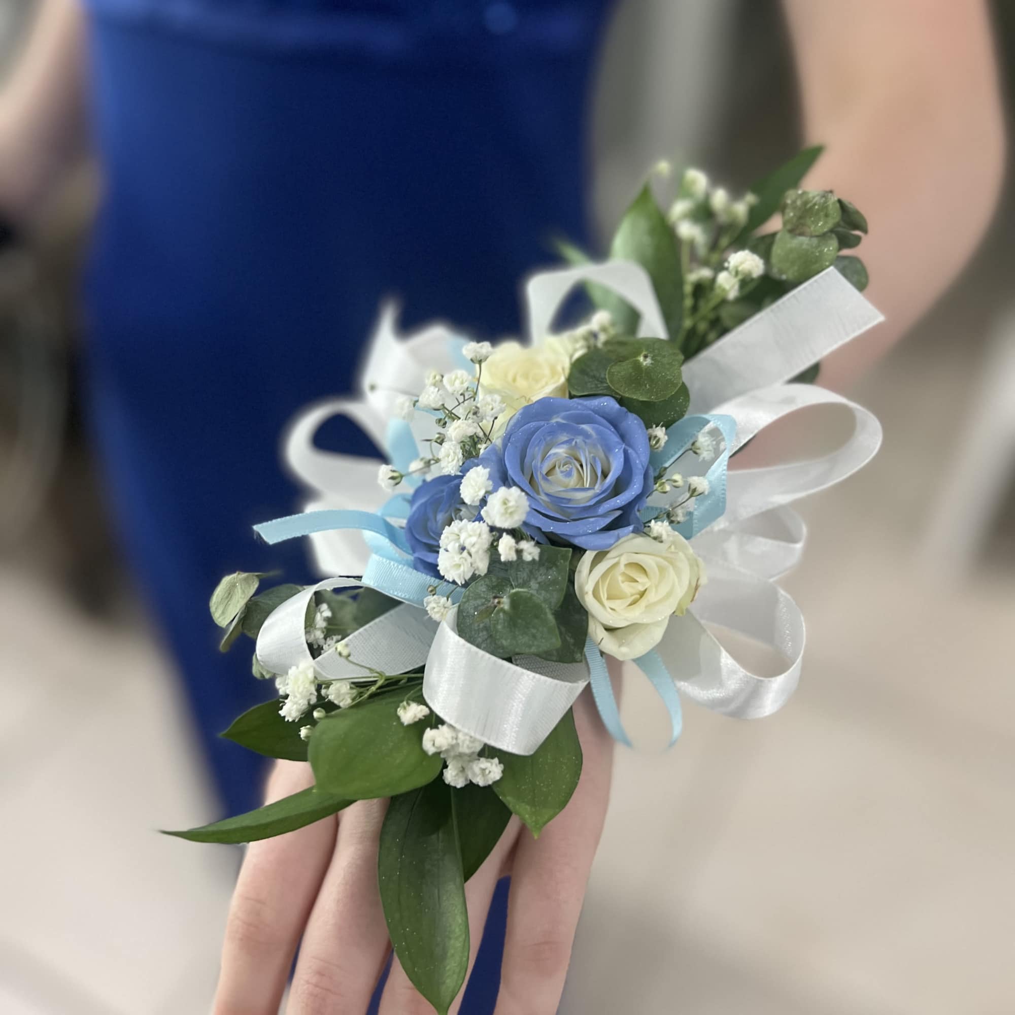 Small wrist corsage with blue and white roses and ribbon, photo 2 of 9