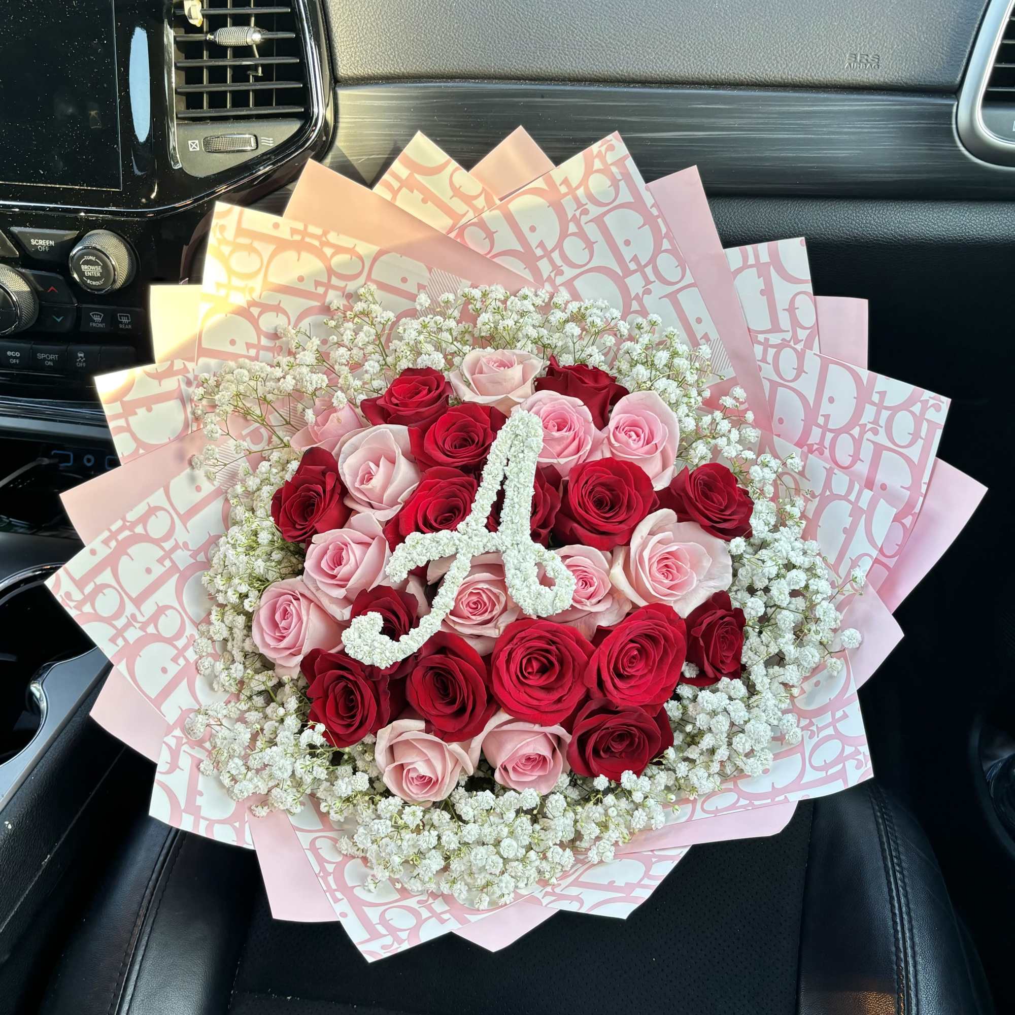 Bouquet of red and pink roses with white filler flowers