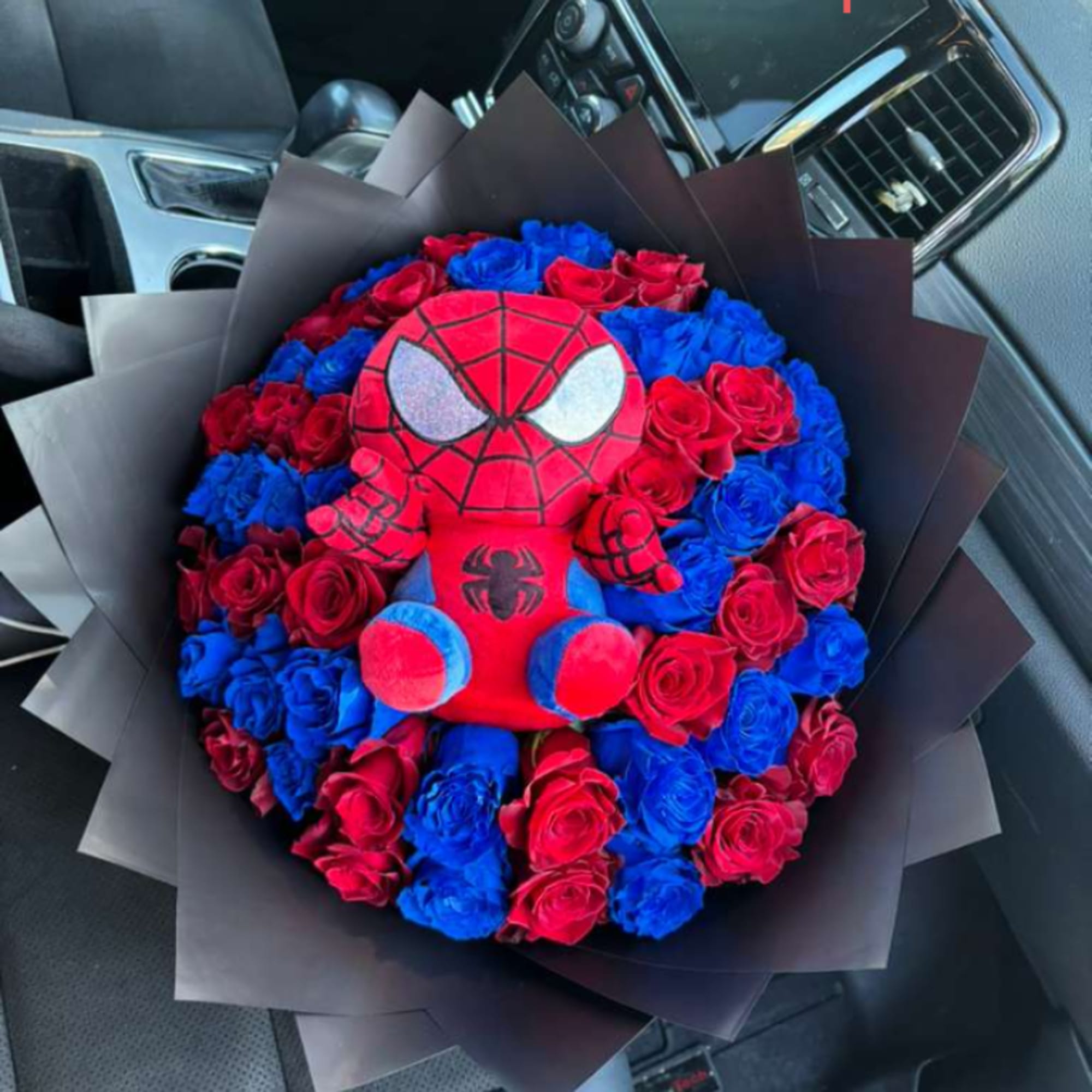 Bouquet of red and blue roses with a Spider-Man plush centerpiece