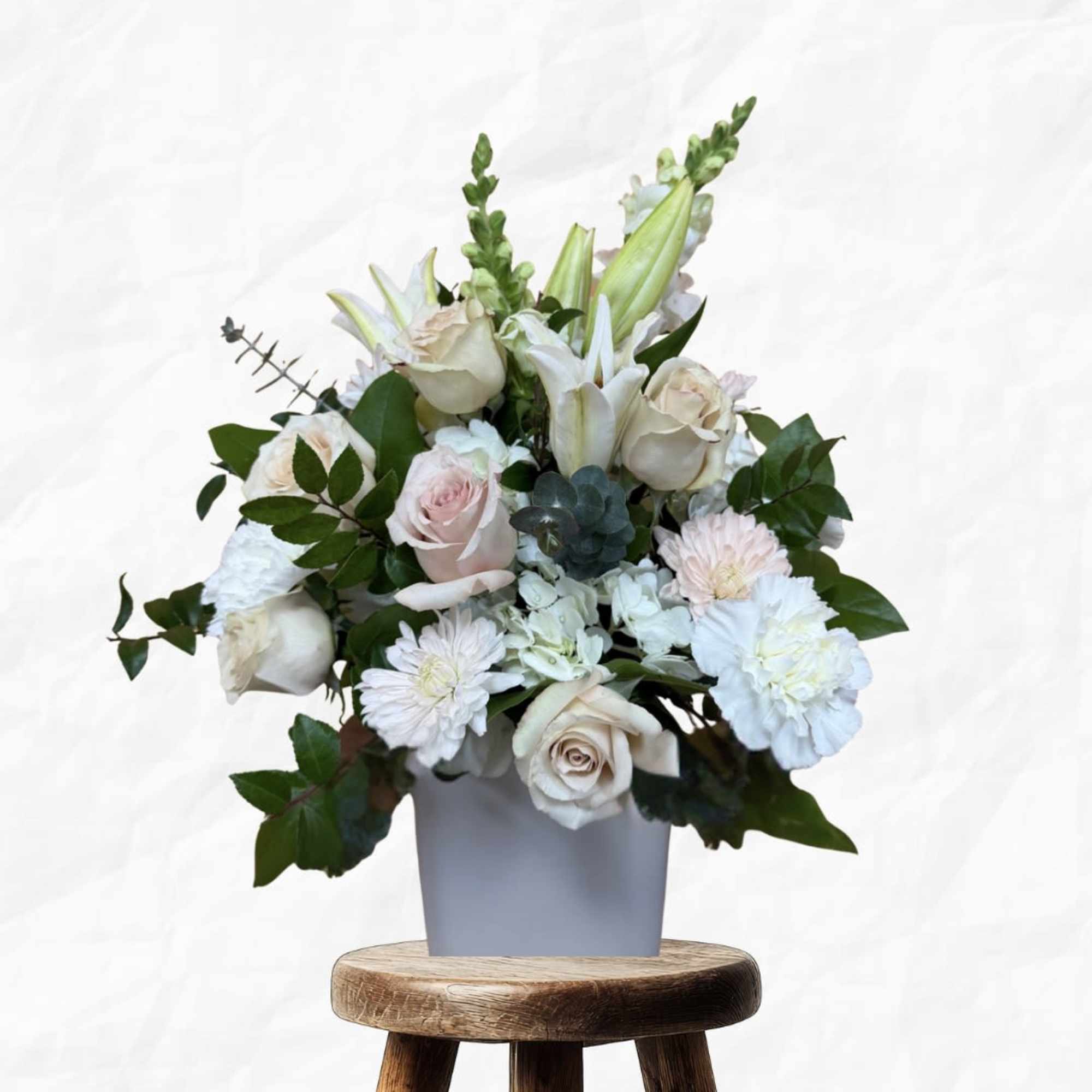 Cream and pale pink bouquet in a gray vase