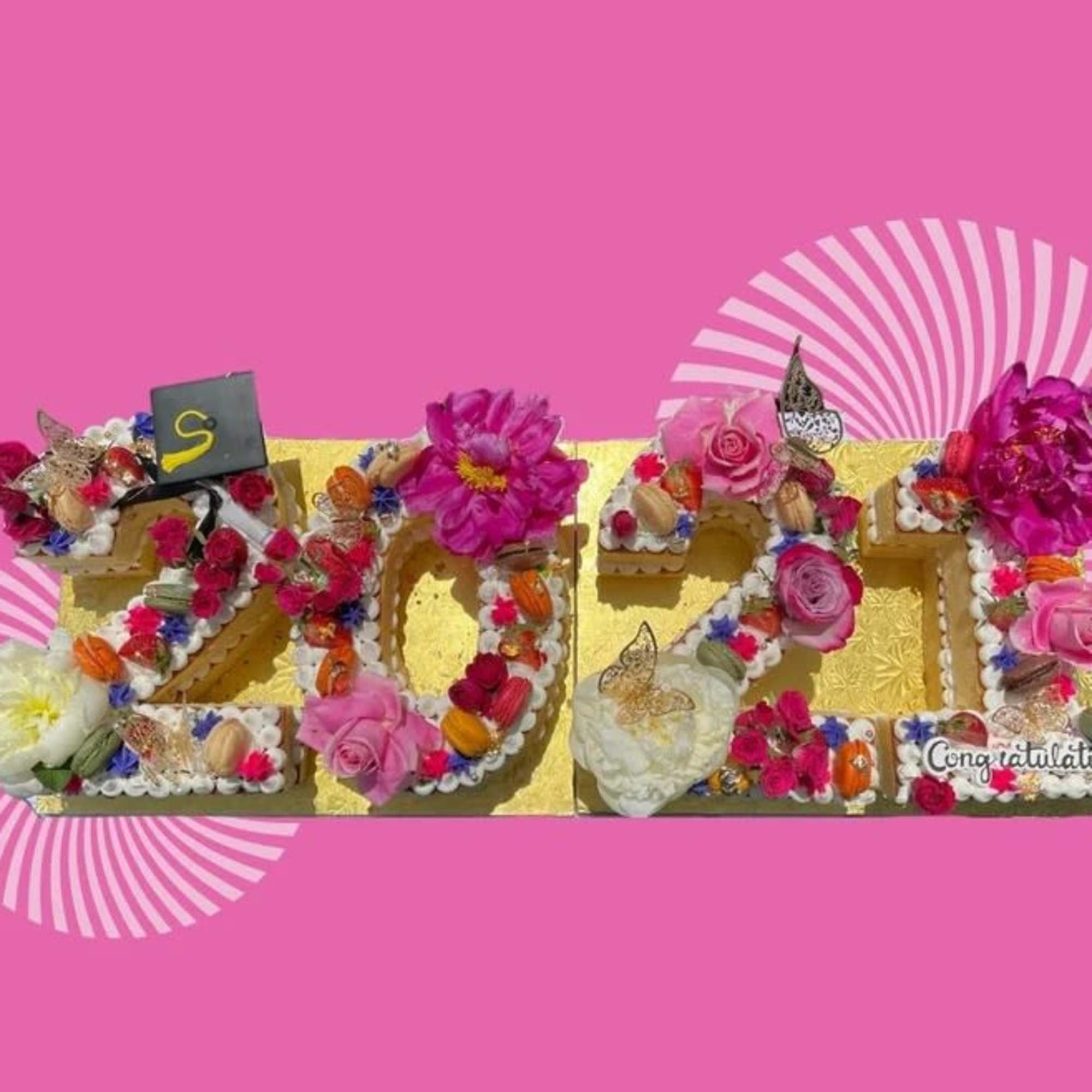 Decorative floral arrangement spelling 2024 with pink and white flowers