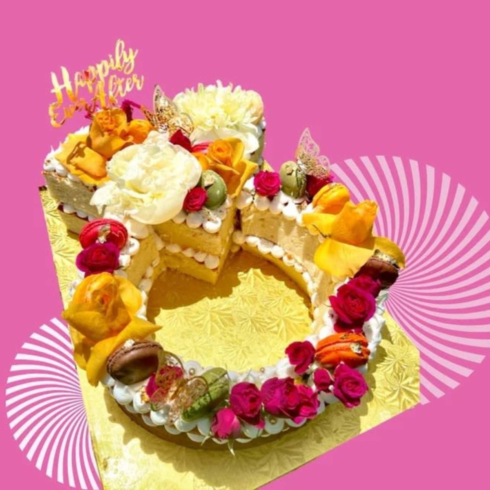 Decorated cake with flowers and a "Happily Ever After" topper
