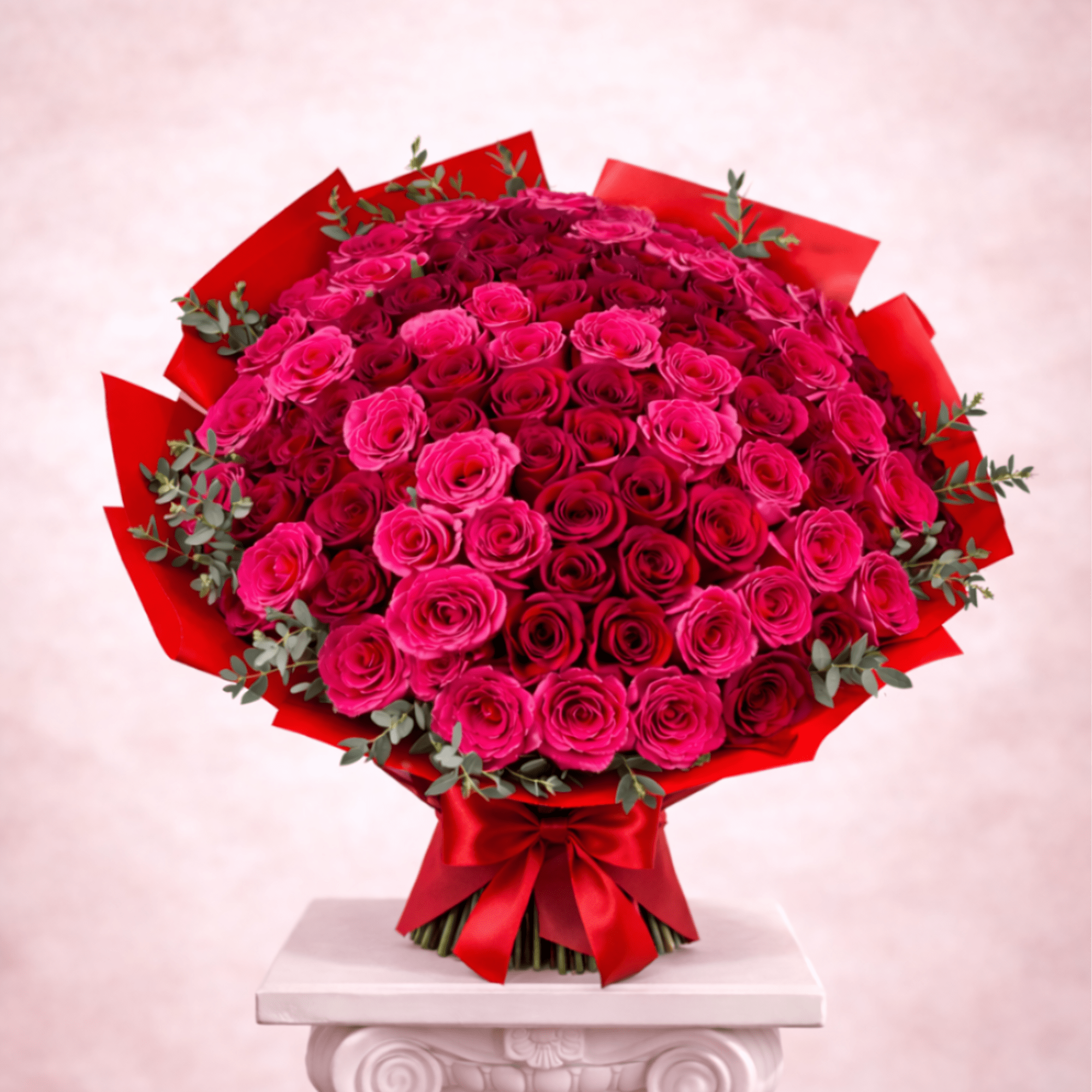 Large bouquet of pink and red roses wrapped in red paper