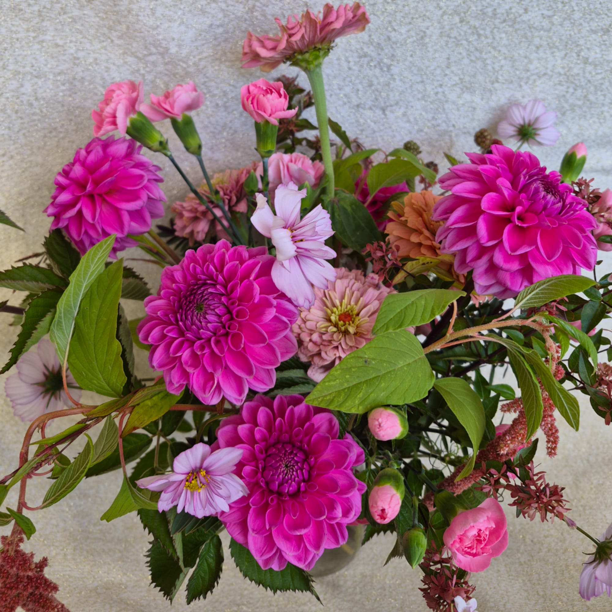 Bright pink and lavender mixed flower bouquet in a vase