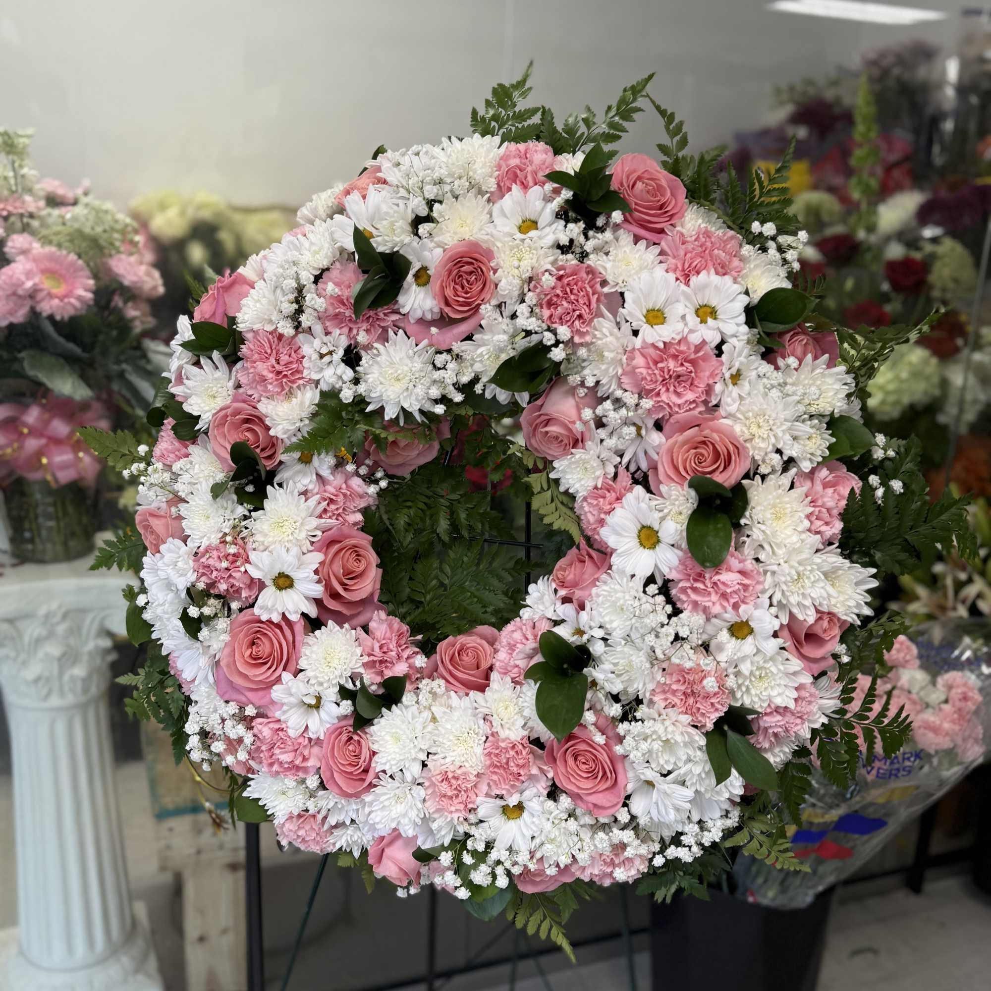 Pink and white floral wreath on a stand, photo 3 of 3