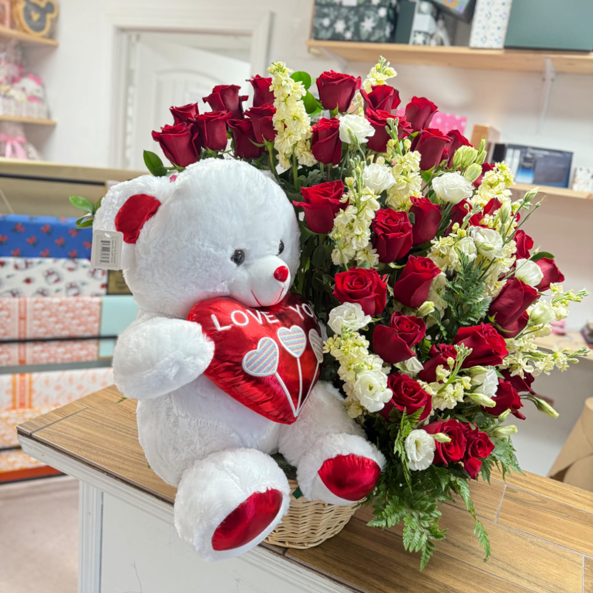 Red roses and white flowers in a basket with a teddy bear holding a heart, photo 2 of 4