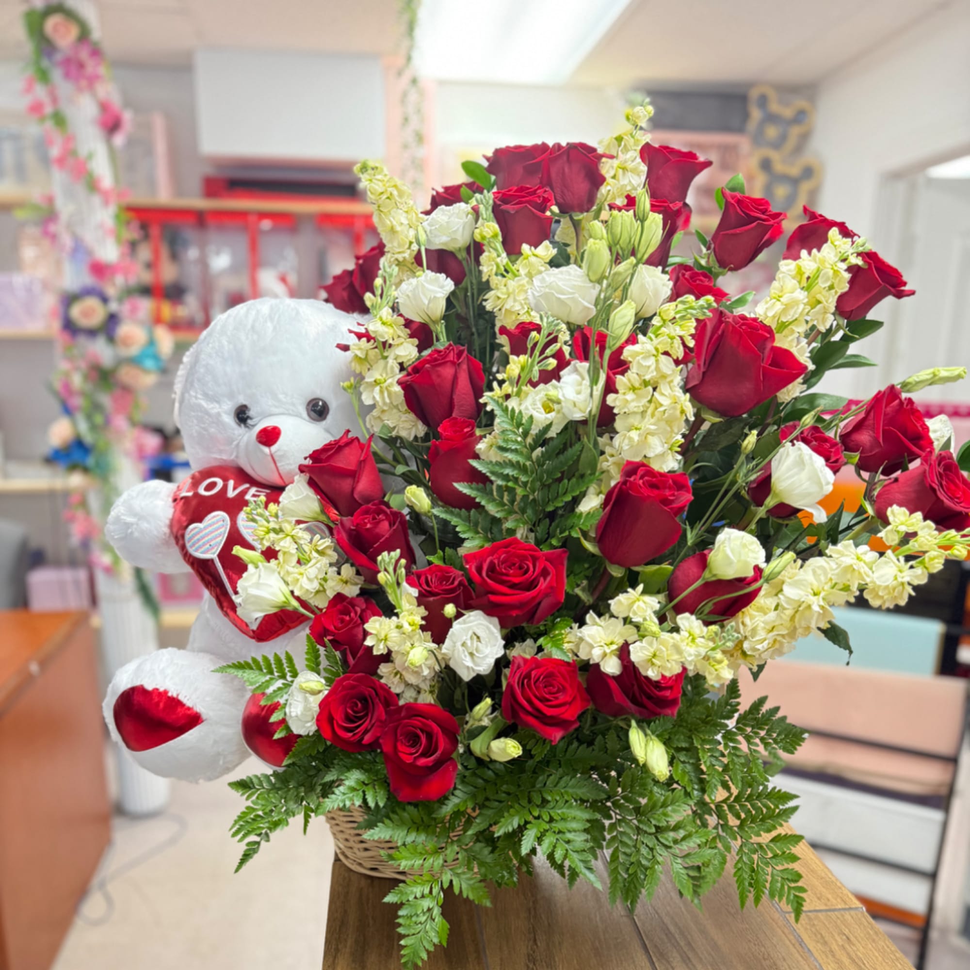 Red roses and white flowers in a basket with a teddy bear holding a heart, photo 3 of 4