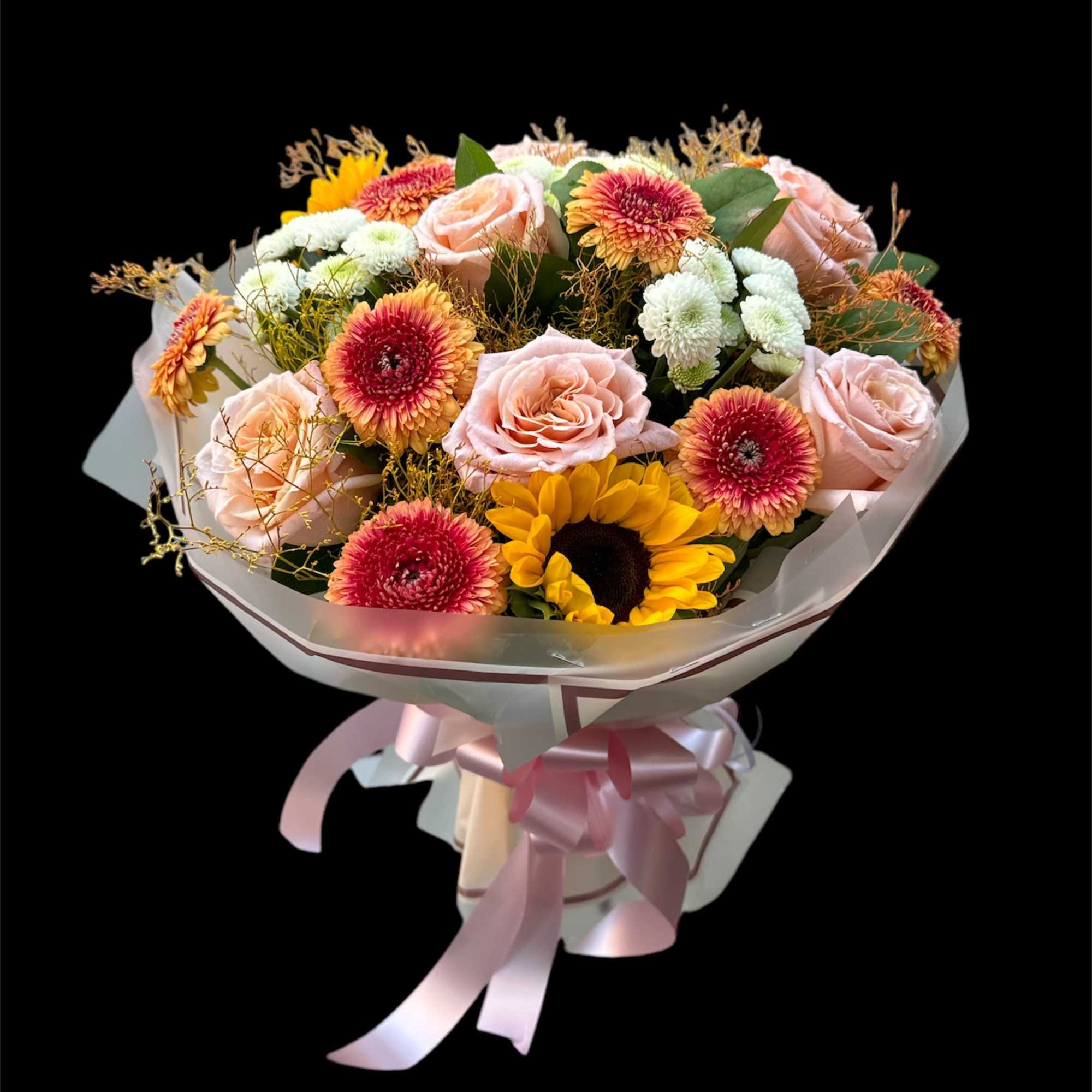 Bouquet of pink roses, sunflowers, and mixed daisies wrapped in pink ribbon