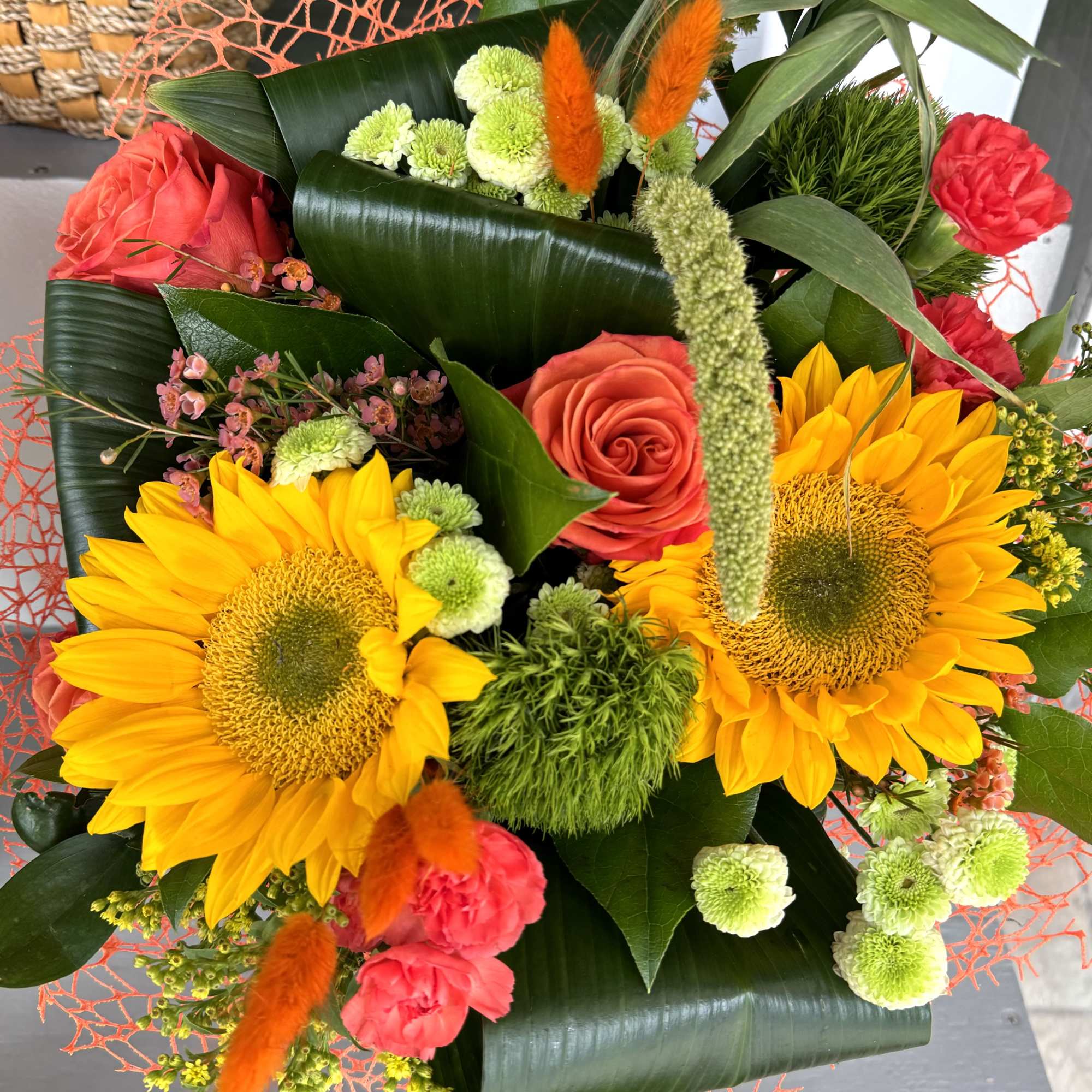 Bouquet with sunflowers, red roses, and pink carnations