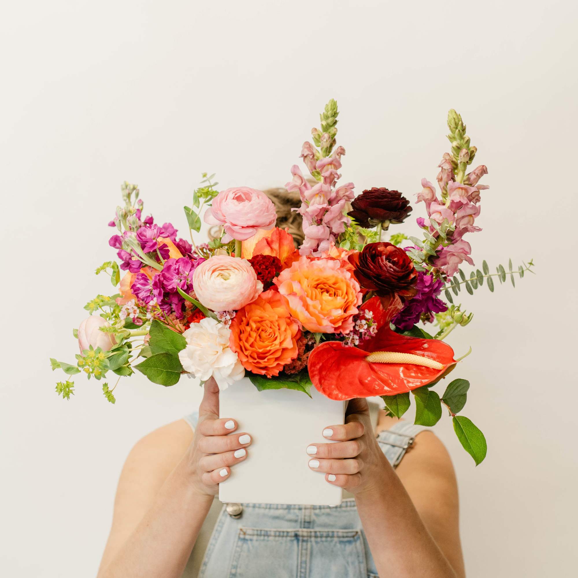 Colorful mixed bouquet in a white box with red anthurium