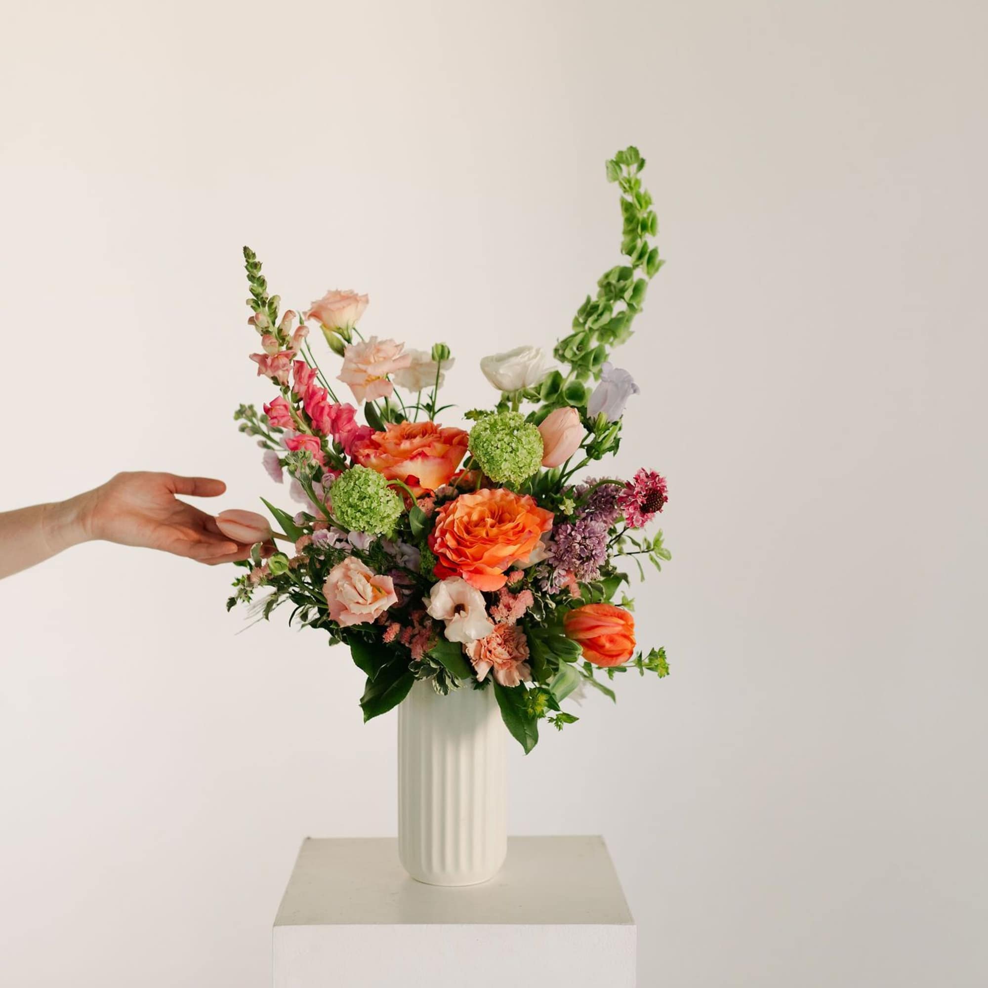 A lush blend of peaches, blush pinks, soft lavenders, and fresh greens