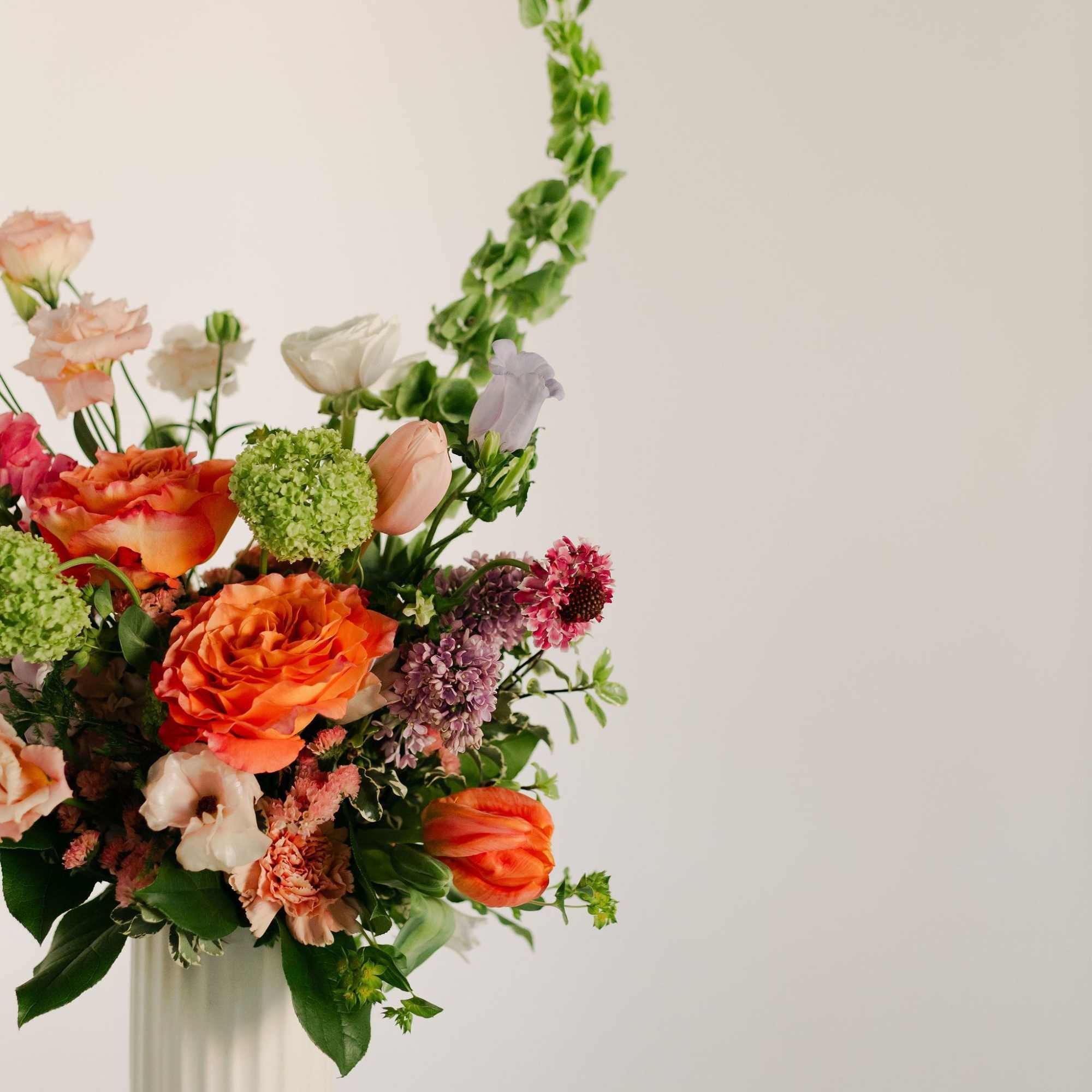 A lush blend of peaches, blush pinks, soft lavenders, and fresh greens, photo 4 of 4