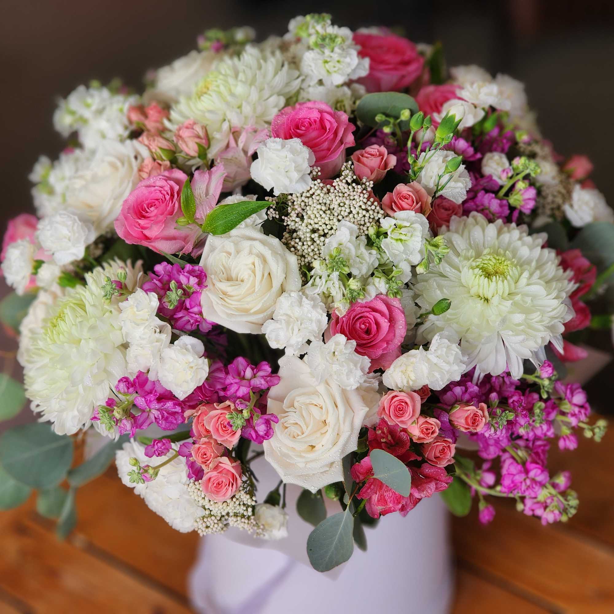 Bouquet of pink and white roses with white chrysanthemums in a vase
