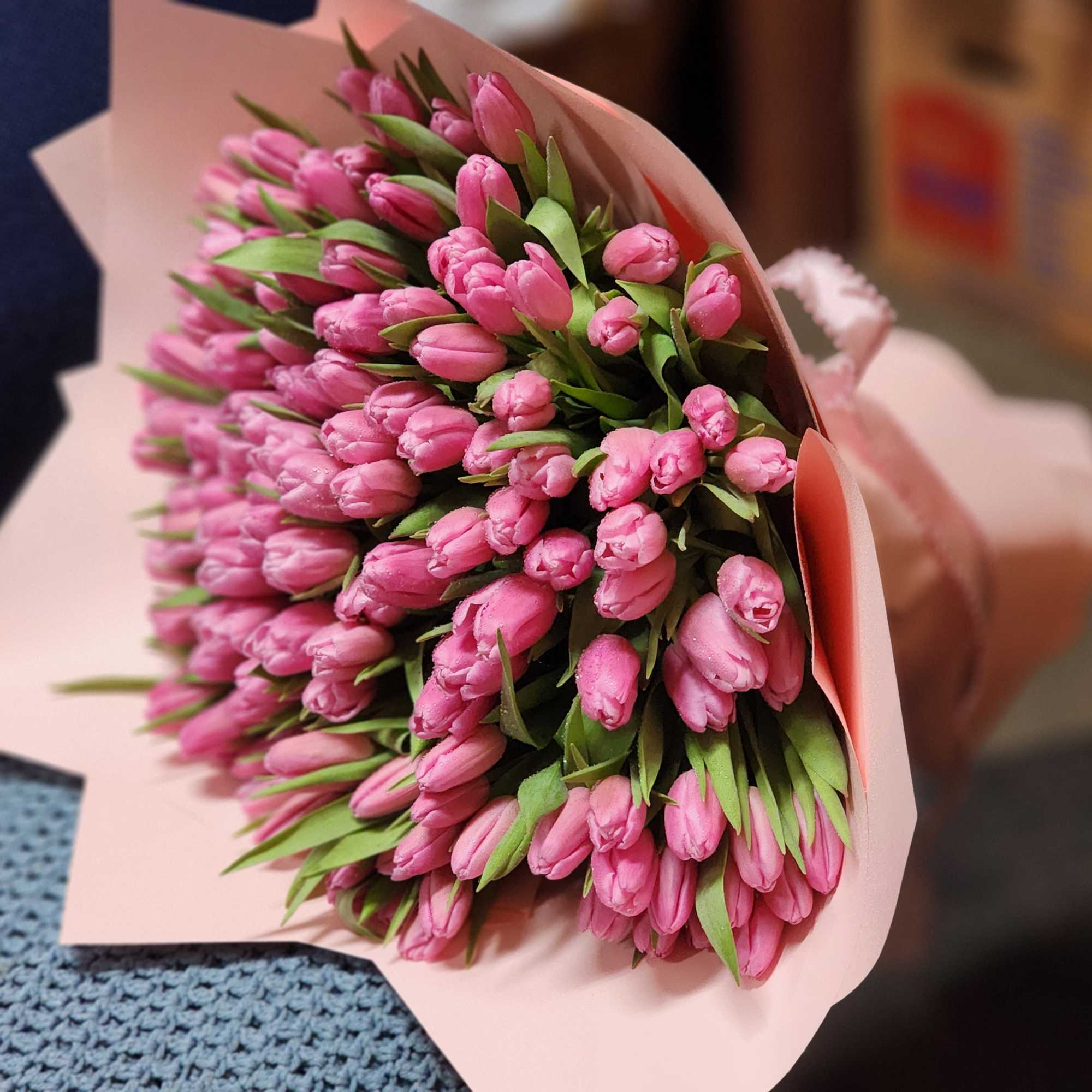 Bouquet of pink tulips wrapped in pale pink paper