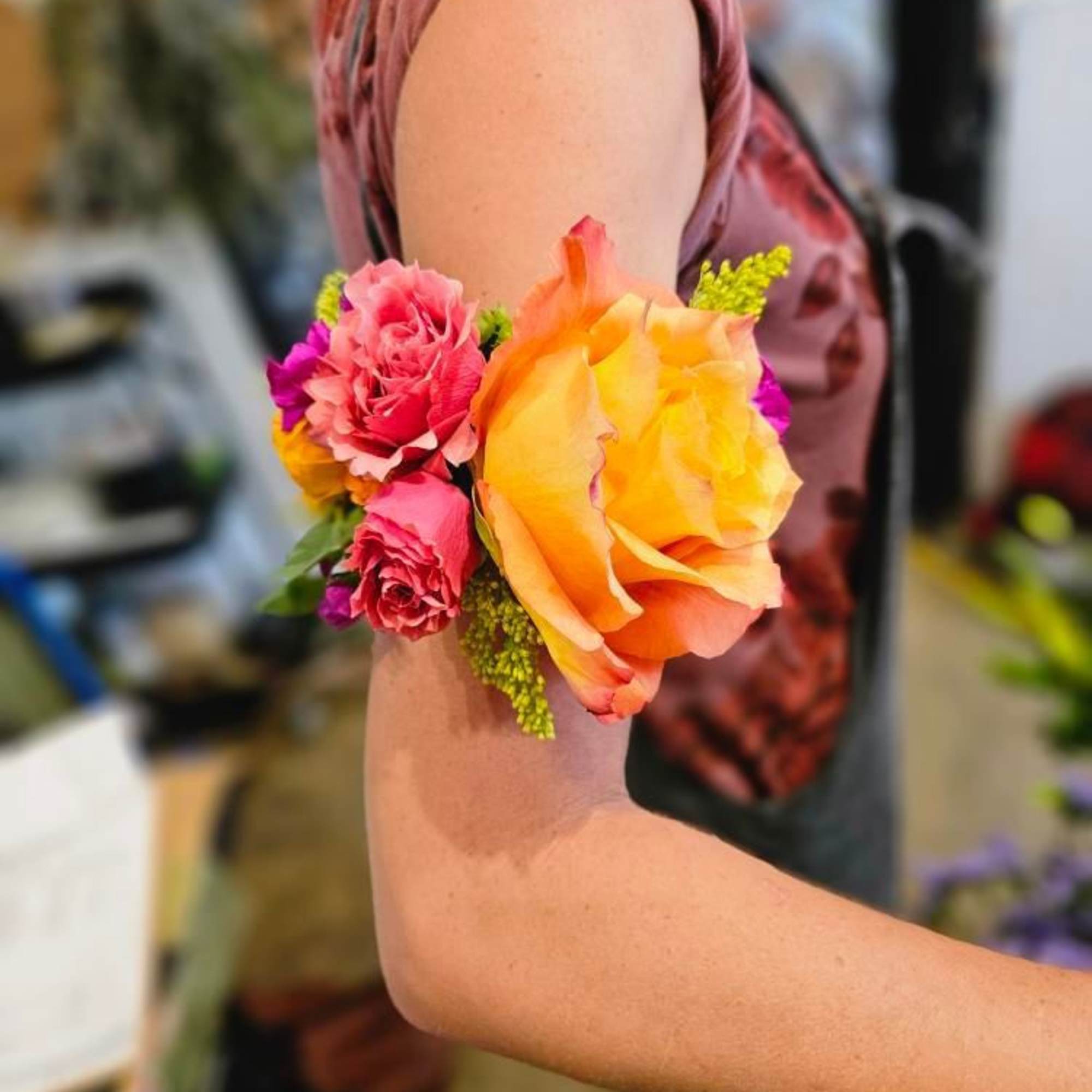 Wrist corsage with orange and pink roses